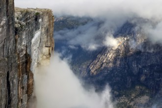 Impressive scene with misty cliffs over Lysefjord, Kjerag, Rogaland, Norway