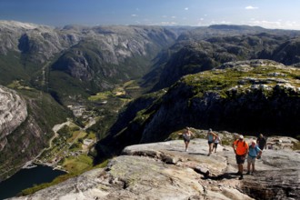 Hikers enjoy spectacular views while climbing Kjerag, Lysefjord, Rogaland, Norway