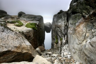 The famous Kjeragbolten between two rock faces near Lysefjord, Kjerag, Rogaland, Norway
