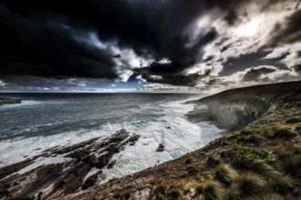 Gloomy coastal atmosphere with strong waves and dark clouds near Cape du Couedic, Kangaroo Island,