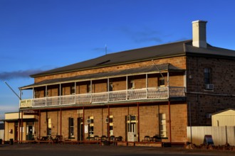 Historic Marree Hotel with impressive veranda and clear blue sky, Marree, South Australia,