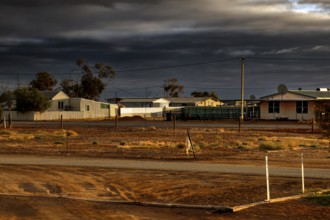 Small village in Marree under a dramatically cloudy sky, Marree, South Australia, Australia
