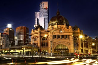 Flinders Street Station at night with magnificent lighting against an urban backdrop, Melbourne,