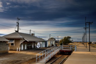 Abandoned train station in Marree with secluded tracks and dramatic skies, Marree, South Australia,