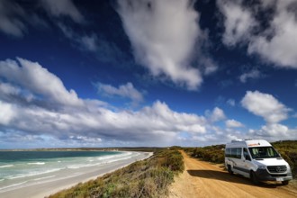 A campervan is parked on a sandy road along a picturesque coast, Vivonne Bay, Kangaroo Island,