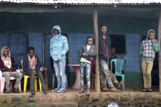 People in front of simple building in Rira, Bale Mountains, cool atmosphere, Rira, Bale Mountains,