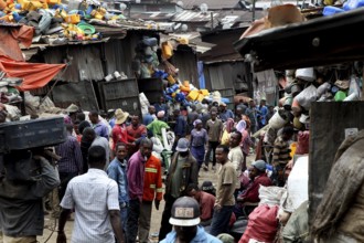 Large crowds of people on the busy Mercato in Addis Ababa, surrounded by colorful fabrics, Addis