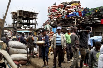 Merchants sell goods amid huge bales of fabric on the busy Mercato in Addis Ababa, Addis Ababa,