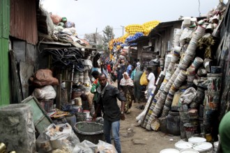 Narrow market alleyway full of people and stacked pots on the Mercato in Addis Ababa, Addis Ababa,