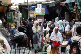 Crowded people in a busy market under narrow streets, Addis Ababa, Mercato, Ethiopia