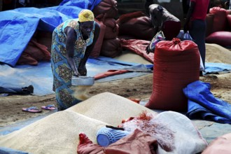 Market scene in Jinka with a woman selling Teff out of a sack