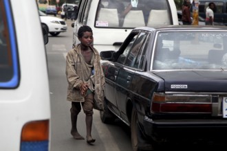 Street scene in Addis Ababa with a boy running between cars. Lively urban atmosphere, Addis Ababa,