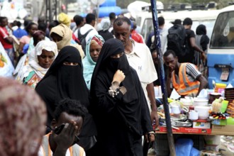 Veiled woman in a busy marketplace in Addis Ababa, Addis Ababa, Ethiopia