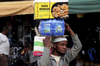 Salesman balances goods upside down in the Mercato of Addis Ababa, Addis Ababa, Ethiopia