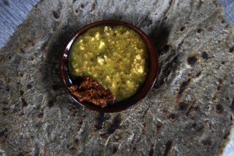 Ensete bread patties with a bowl of yellow sauce in Dorze village, Dorze village, Ethiopia