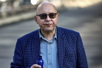 Man wearing checkered suit and sunglasses walks on the street in Tallinn, Tallinn, South Alinn,