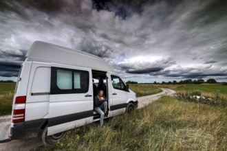 Transporter on a dirt road in Vilsandi National Park under dramatic clouds, Vilsandi National Park,
