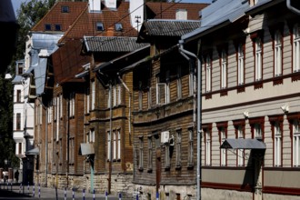 Row of historic wooden houses in Kelmiküla with decorated facades, Tallinn, Harju, Estonia