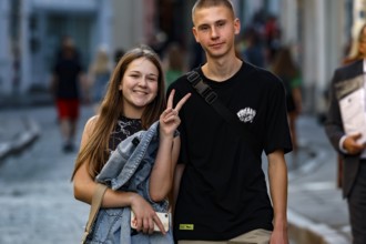 A young couple walking through the old town smiling and enjoying the day, Tallinn, Harju, Estonia
