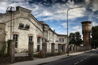 Historic factory buildings under cloudy sky in Telliskivi Creative Campus, Tallinn, Kelmiküla,