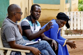 Adama Coulibaly interviews Alassane and Rokia during a home visit to CI, Korhogo, CI, Côte d'Ivoire