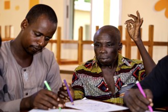 People in CI Korhogo focus on painting therapy with colorful pencils, Korhogo, CI, Côte d'Ivoire