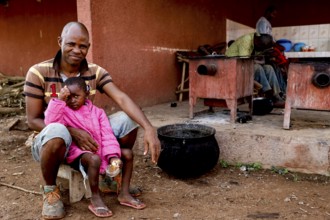 Worker sitting with his daughter in a rehabilitation center for the mentally ill, Nongotanakaha,