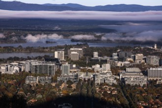 Overview of Mount Ainslie Lookout on Canberra amid surrounding mountains and morning light,