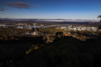 Panoramic view of Canberra from Mount Ainslie Lookout, framed by wide sky and clouds, Canberra,