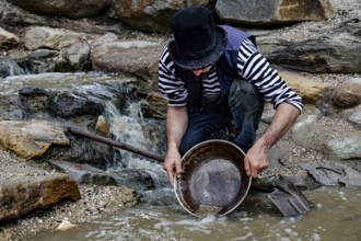 Gold miner washes gold in a stream in Sovereign Hill, Ballarat, Ballarat, Victoria, Australia