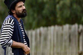 A performer wearing traditional dress looks seriously into the distance, Ballarat, Australia