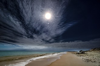 Car beaches at sunset with wide skies over Cable Beach, Broome, Western Australia, Australia