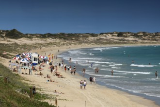 Busy cable beach with lots of visitors under blue skies, Broome, Western Australia, Australia