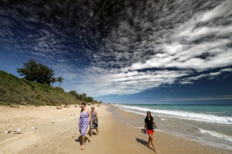 Group of people walking along sunny Cable Beach, Broome, Western Australia, Australia