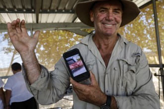 Man proudly shows the scar from a crocodile attack on his arm, Adelaide River, Northern Territory,