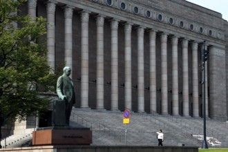 The Finnish Parliament in Helsinki with a statue and impressive pillars, Helsinki, Uusimaa, Finland