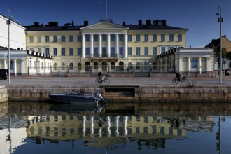 Presidential Palace on Kauppatori in Helsinki with majestic architecture and water reflections,
