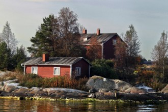 Wooden house on an island near Helsinki, surrounded by autumn-colored trees, Helsinki, Finland
