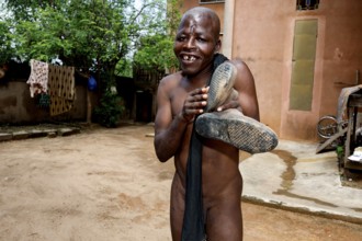 Happy man posing playfully in the courtyard of a psychiatric facility in Bouaké, Bouké, Côte