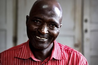 Smiling employee named Honoré in a men's psychiatric ward in Bouaké, Bouaké, Nimbo, Côte d'Ivoire