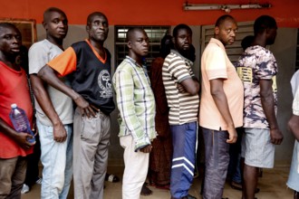 Men line up to dispense medication in a men's psychiatric ward, Bouaké, Nimbo, Côte d'Ivoire