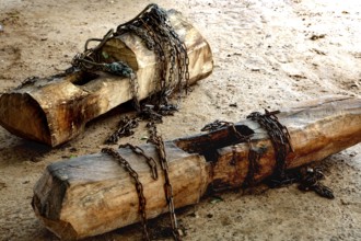 Rough logs with heavy chains as a sign of psychological imprisonment, Bouaké, Ivory Coast