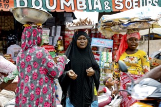 Bustling market with various goods and people in a cheerful atmosphere, CI Bouaké, Ivory Coast