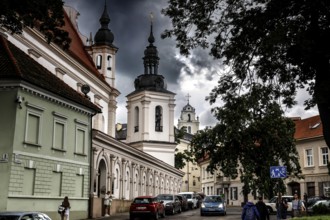 Street in Vilnius with a view of a monumental church and dramatic sky, Vilnius, Vilnius County,