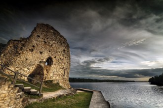 Kokenhusen castle ruins on the riverbank under dramatic sky, Koknese, Kokenhusen, Latvia
