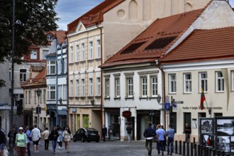 Architecture of an old town street with pedestrians in Vilnius under cloudy sky, Vilnius, Vilnius