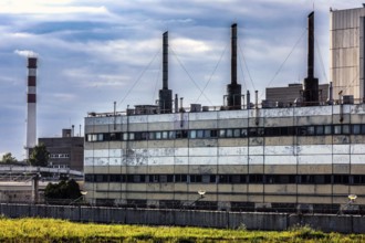Large disused power plant with several chimneys against a cloudy sky, Visaginas, Lithuania
