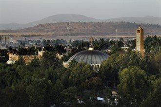 View of St. Mary's Cathedral in Axum from Yeha Hotel with surrounding greenery and mountains in the