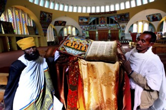 Priests present an opened Bible at St. Mary's Cathedral in Axum during a ceremony, Axum, Tigray,