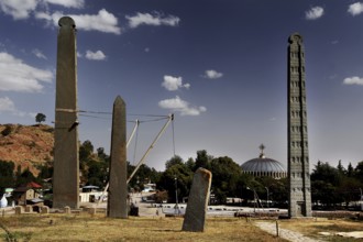 Steles and a church in the background under a clear sky, Axum, Tigray, Ethiopia